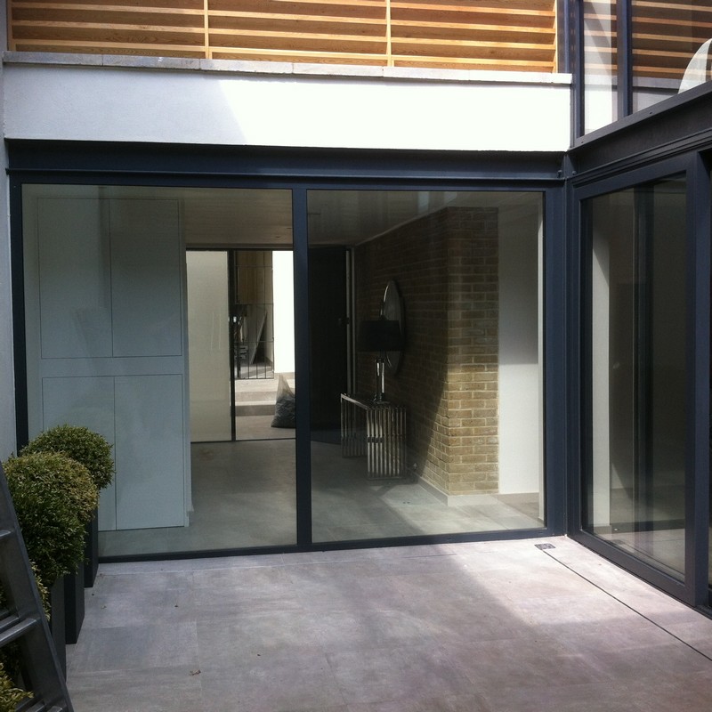 Floor-to-ceiling sliding doors opening to courtyard in Welwyn Garden City