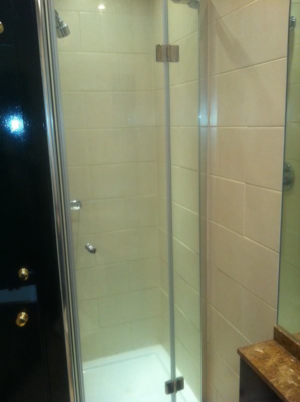 Frameless glass shower enclosure with chrome fittings in Welwyn Garden City